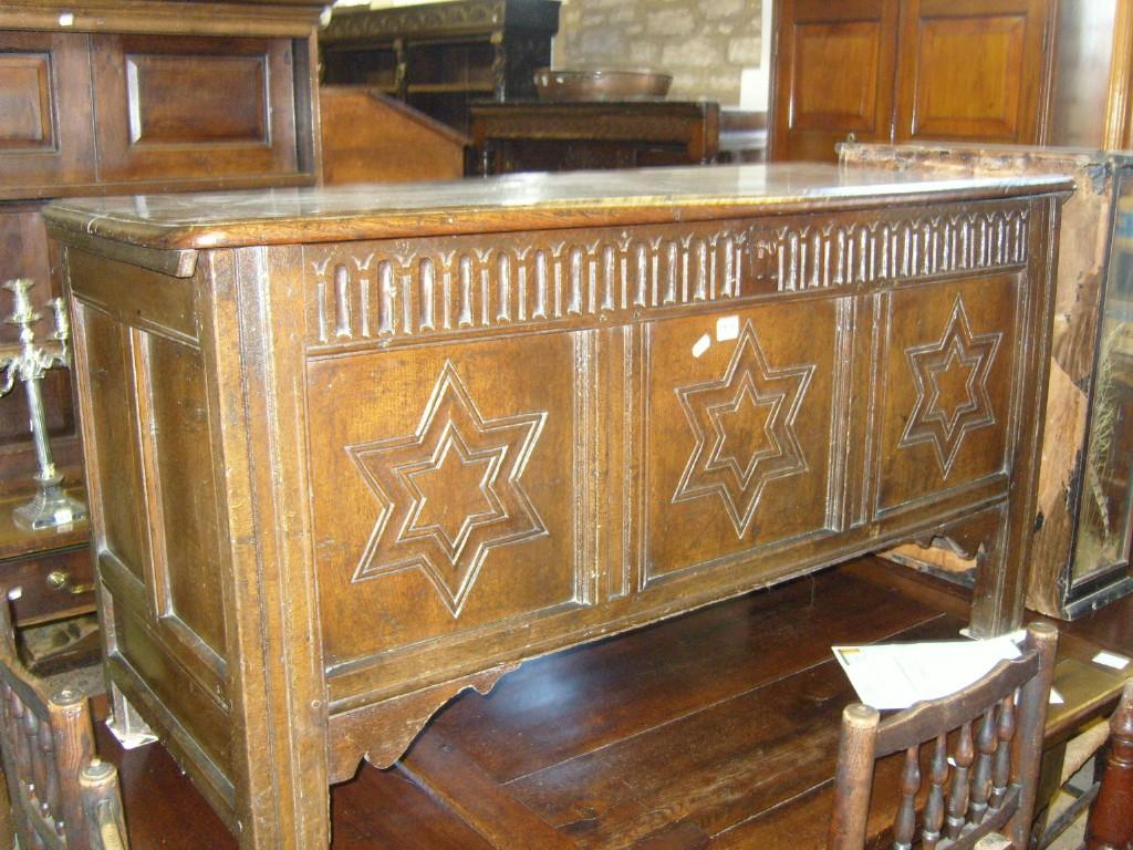 Appraisal: An th century oak coffer with planked top with pegged