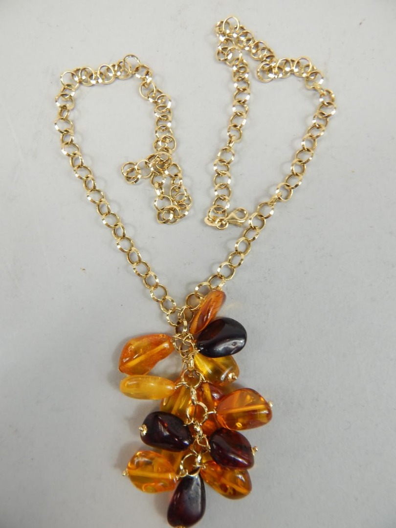 Appraisal: An amber coloured bead and yellow metal necklace stamped Italy