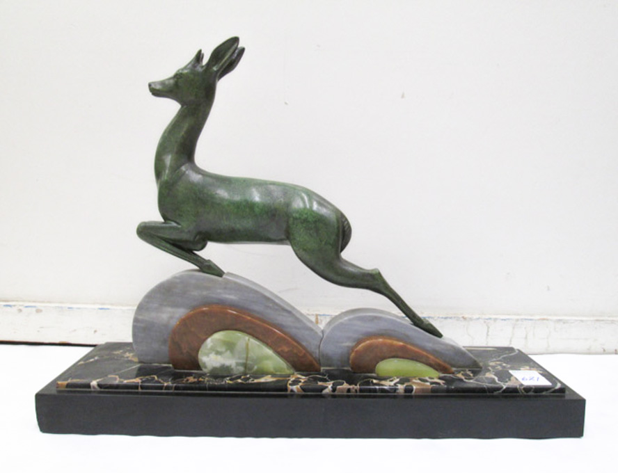 Appraisal: AN ART DECO STYLE BRONZE AND MARBLE SCULPTURE featuring a