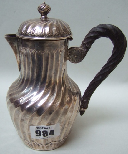 Appraisal: A French hinge lidded hot water jug with rythen fluted