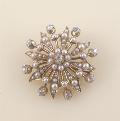 Appraisal: An Edwardian half seed pearl set flowerhead brooch with brilliant