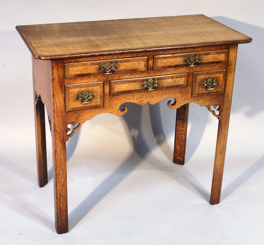 Appraisal: An thC style oak lowboy the shaped top raised above