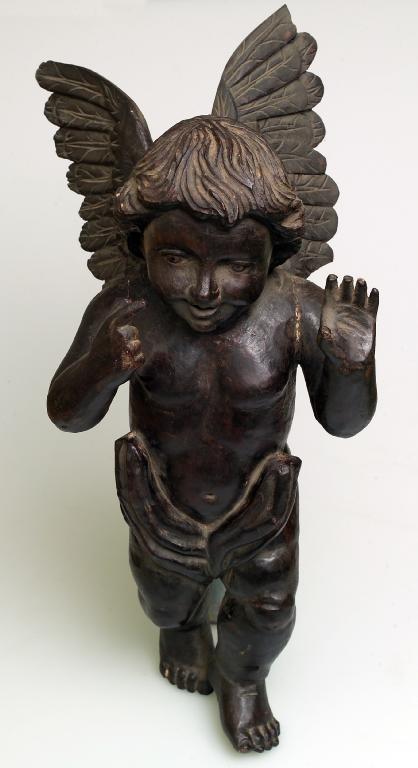 Appraisal: CARVED AND STAINED FRUITWOOD FIGURE OF A PUTTO th th