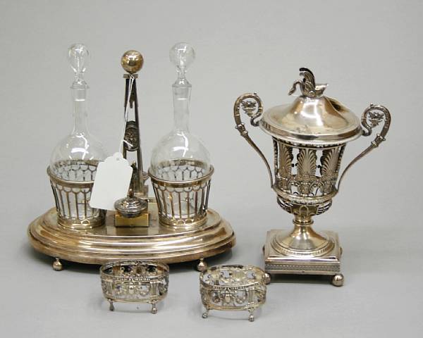 Appraisal: A French silver cruet stand frame with bottle caps and