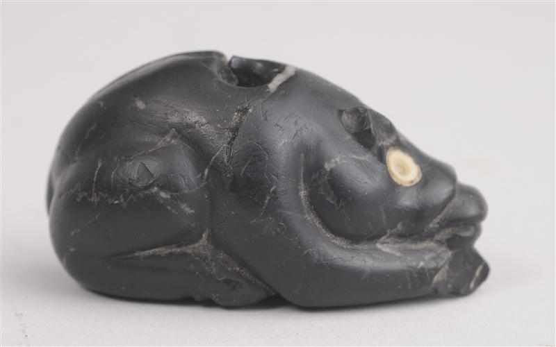 Appraisal: BONE-INLAID CARVED BLACK STONE PENDANT A recumbent cow the flat