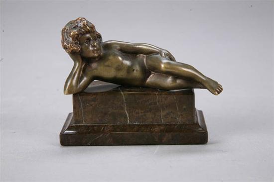 Appraisal: STATUE Small bronze of a reclining cherub on an onyx