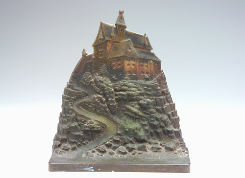 Appraisal: BRADLEY HUBBARD Bronzed doorstop embossed with a mansion on top