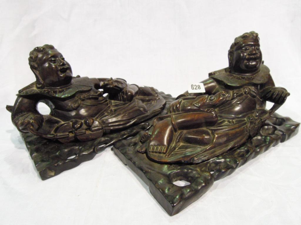 Appraisal: A pair of Chinese hardwood carvings of reclining laughing Buddhas