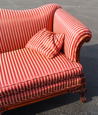 Appraisal: STRIPED CAMEL BACK SOFA Carved frame and front legs ending