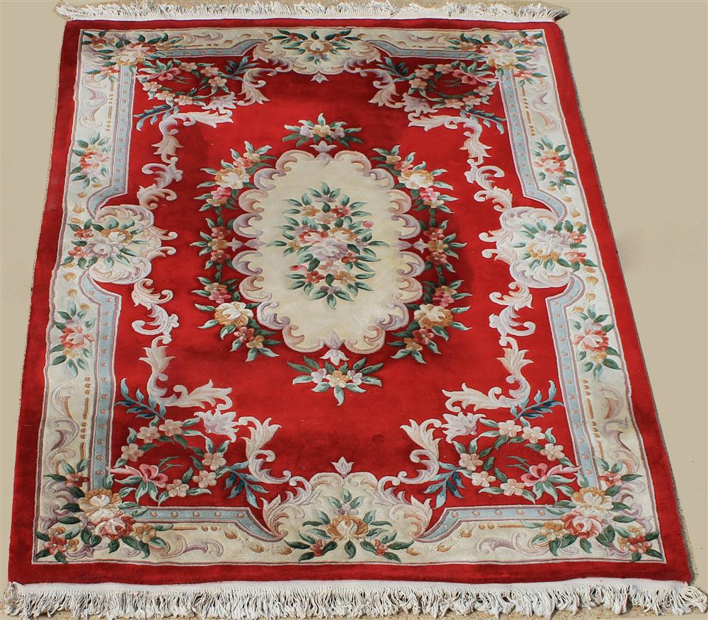 Appraisal: CHINESE WOOL AUBUSSON RUG sculptured design on a red field