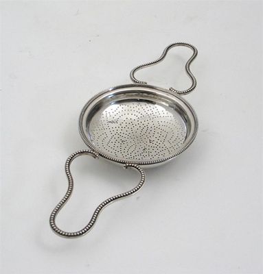 Appraisal: A George III strainer with beaded loop handles and border