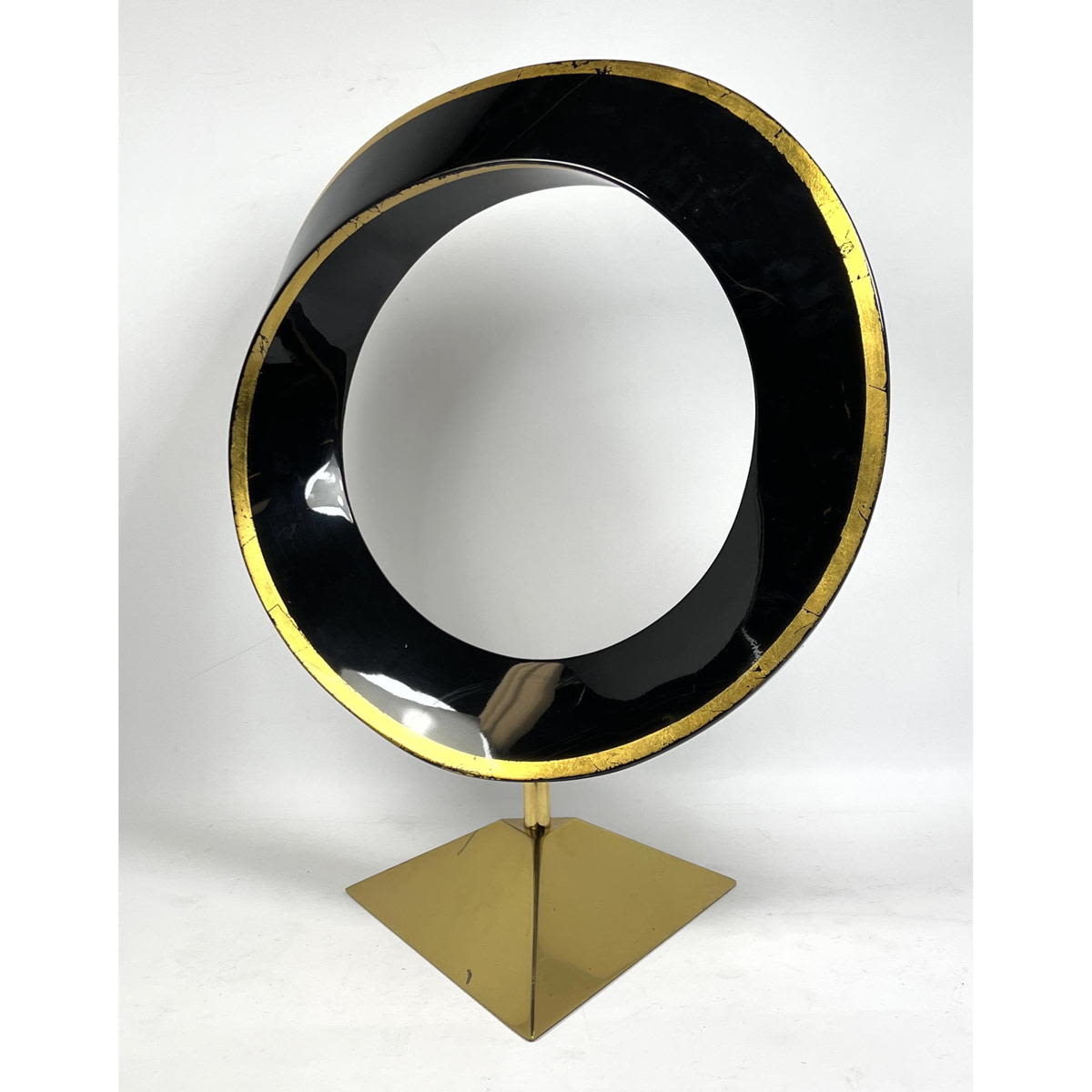 Appraisal: Elegant Modernist Black Resin and Brass Sculpture Twisted black hoop