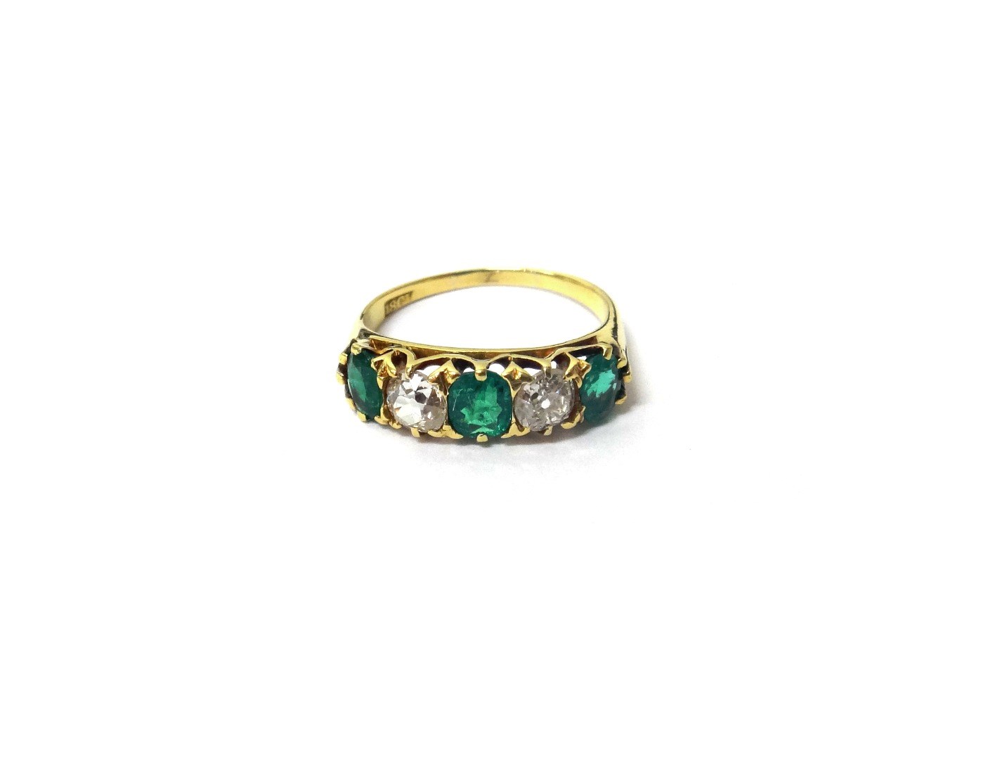 Appraisal: A gold emerald and diamond set five stone ring mounted