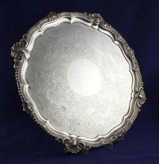 Appraisal: A large Edwardian silver salver of shaped circular form with