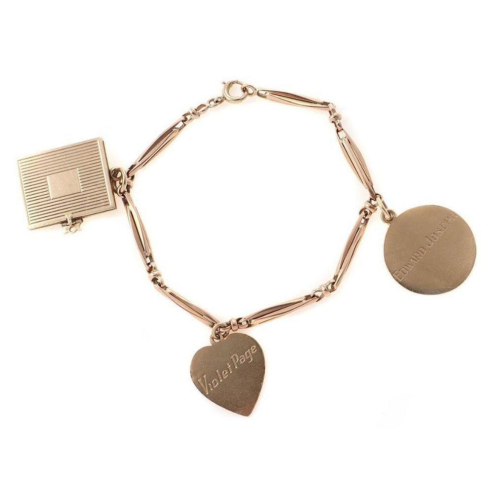 Appraisal: k rose gold charm bracelet suspending three yellow gold charms