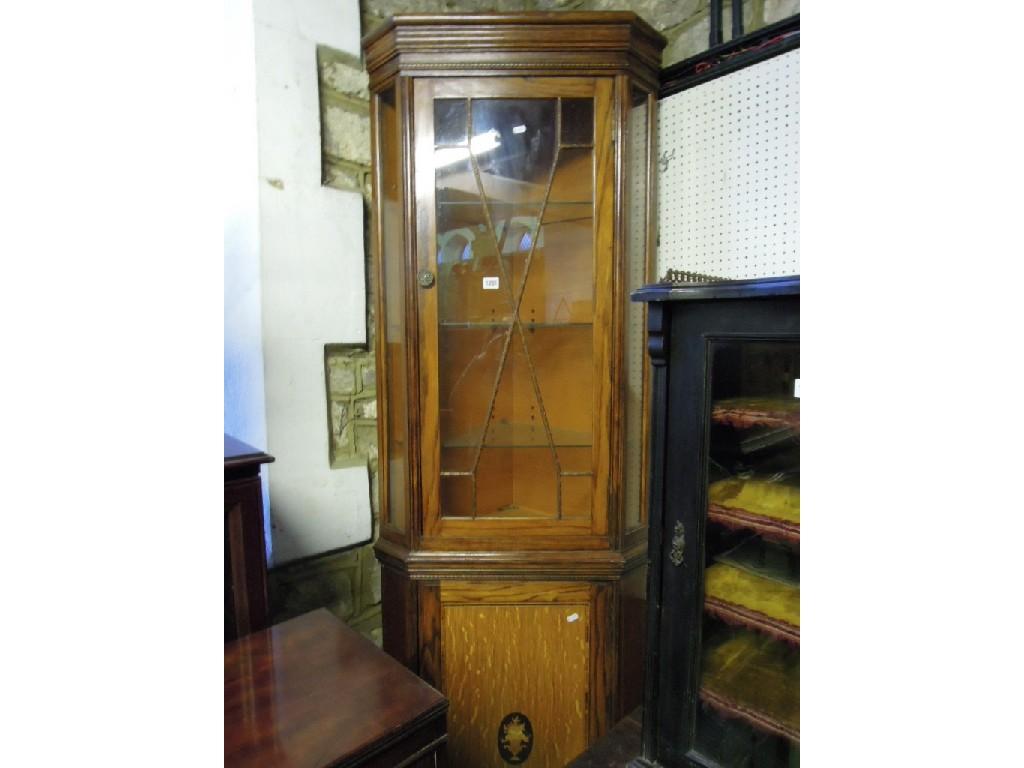 Appraisal: A freestanding oak corner display cabinet the upper section enclosed