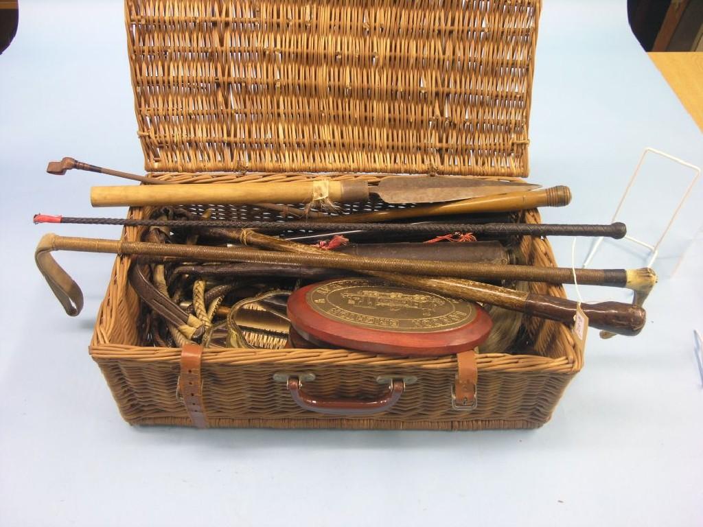 Appraisal: A wicker basket containing various riding crops whips etc