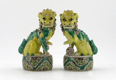 Appraisal: A pair of Chinese models of Buddhistic lion dogs decorated