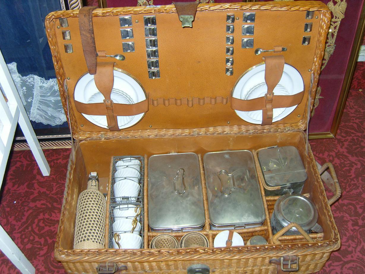 Appraisal: An early th century wicker hamper containing an extensive picnic