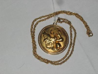 Appraisal: A GILDED METAL SALVADOR DALI MEDALLION of circular form moulded