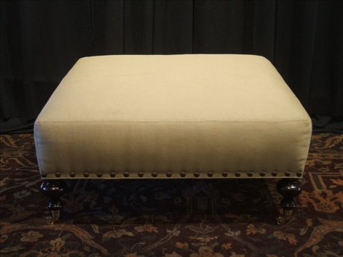 Appraisal: MODERN UPHOLSTERED OTTOMAN The square beige upholstered top raised over