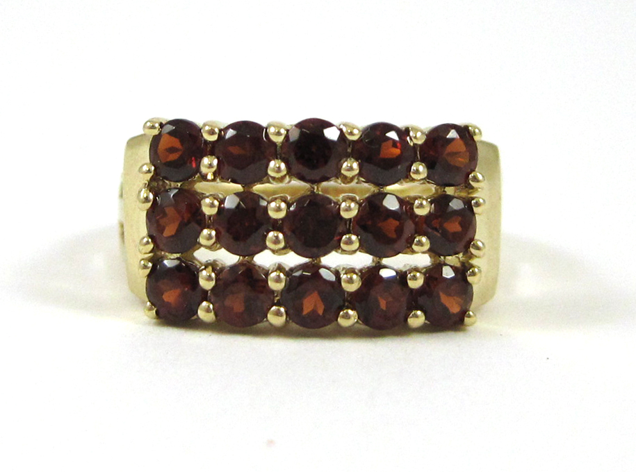 Appraisal: HESSONITE GARNET AND FOURTEEN KARAT GOLD RING set with round-cut