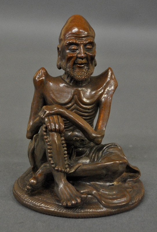 Appraisal: - Asian brown pottery Lo Han Seated figure h x