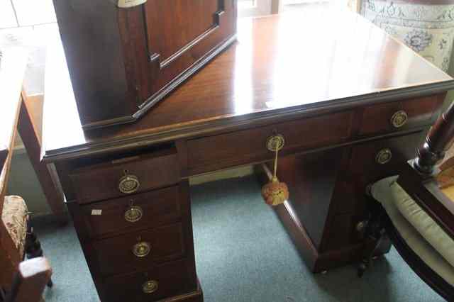 Appraisal: A MAHOGANY PEDESTAL DESK with inlaid rectangular top fitted nine