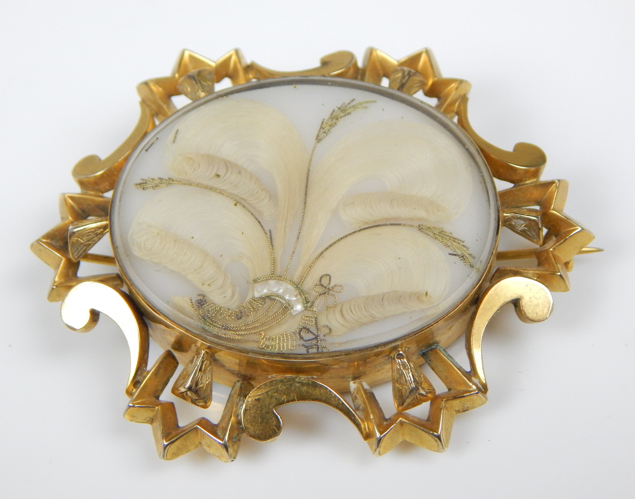 Appraisal: A Victorian gilt metal memorial brooch the hair set with