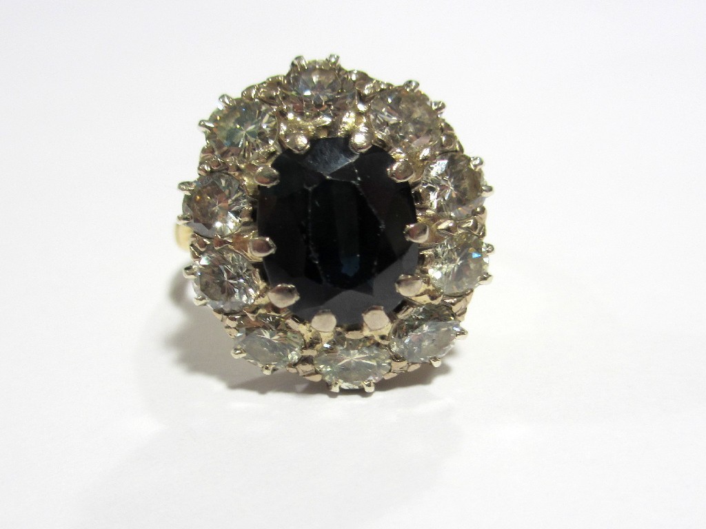 Appraisal: An eighteen carat gold sapphire and diamond cluster ring with