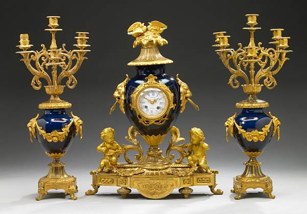 Appraisal: A French gilt bronze mounted porcelain clock garniture late th