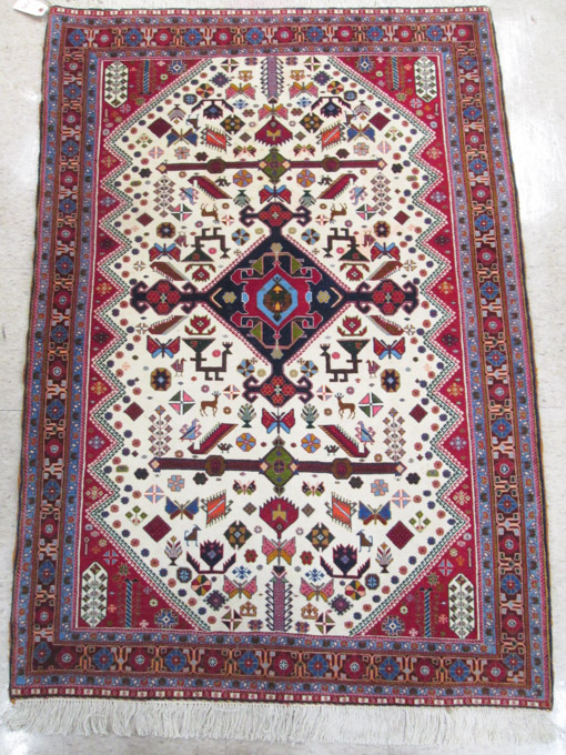 Appraisal: PERSIAN TRIBAL AREA RUG hand knotted in a central geometric