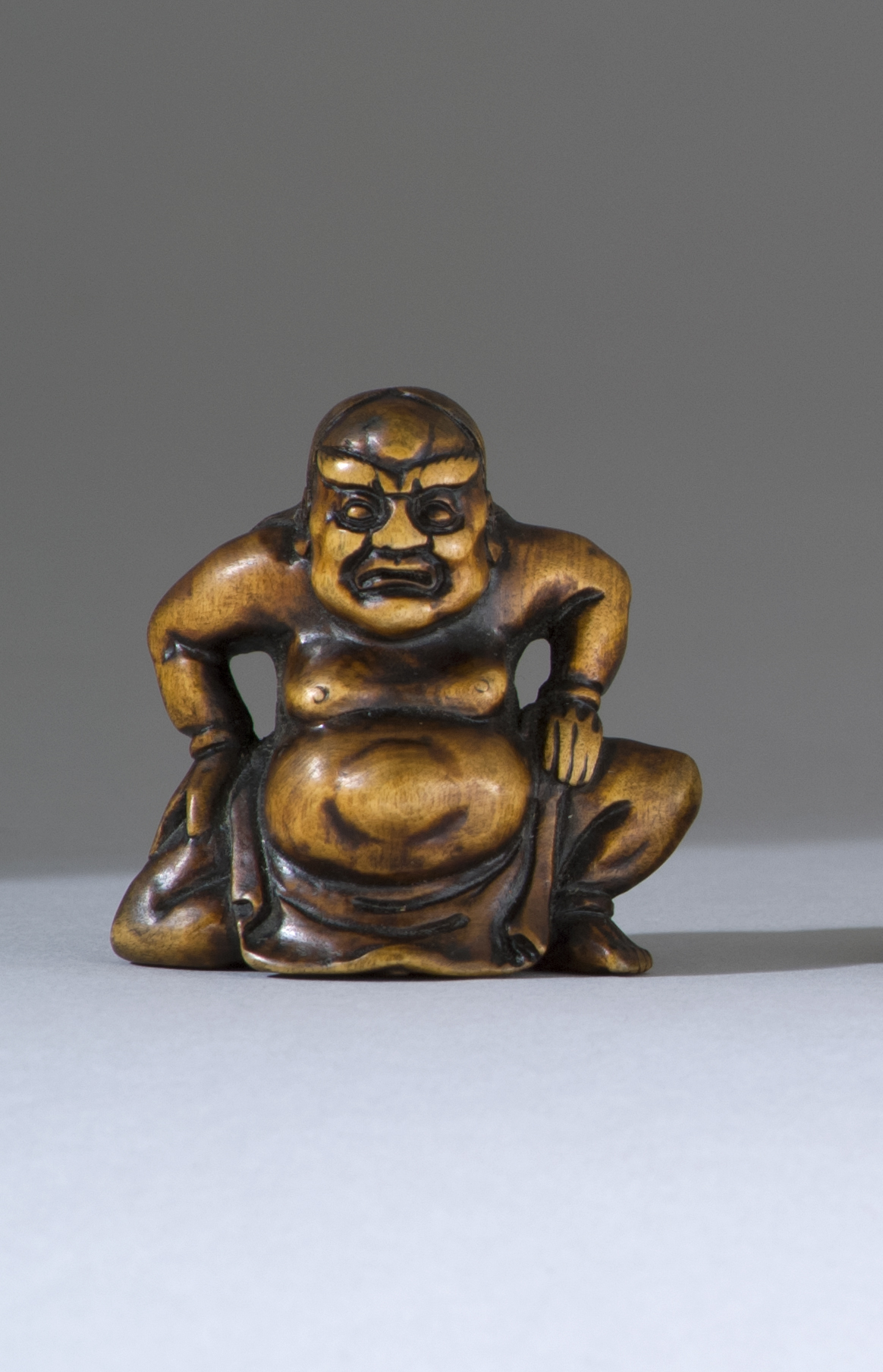 Appraisal: WOOD NETSUKE th CenturyIn the form of a seated nio