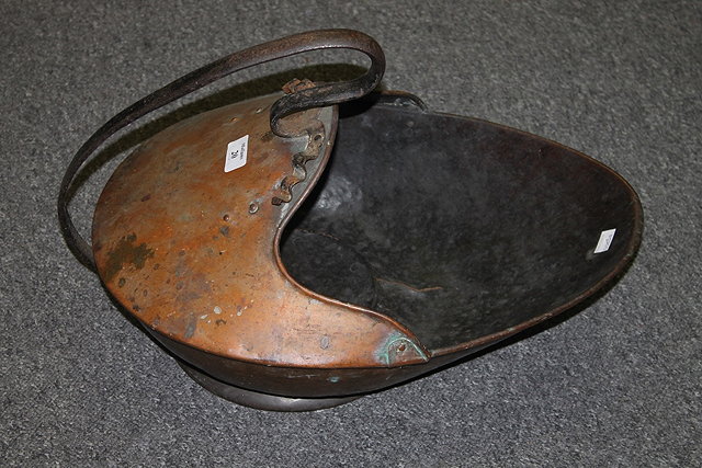 Appraisal: A COPPER COAL SCUTTLE in the manner of Christopher Dresser