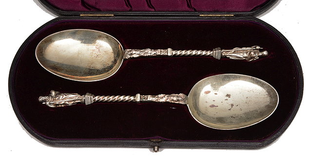 Appraisal: A PAIR OF SILVER APOSTLE TOP SERVING SPOONS with twist