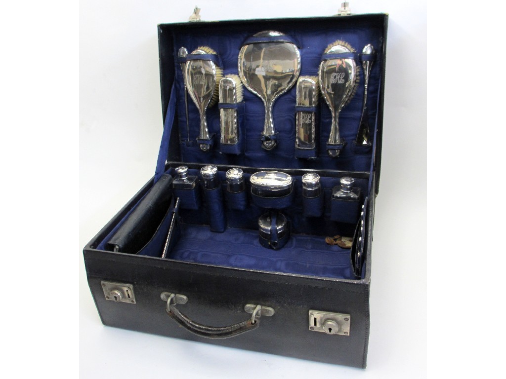 Appraisal: A travel case with silver fittings comprising seven piece silver