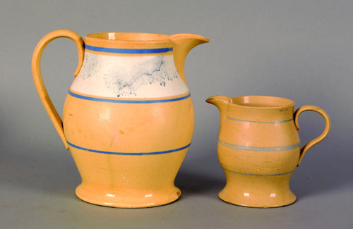 Appraisal: Two yelloware pitchers th c with seaweed and blue band