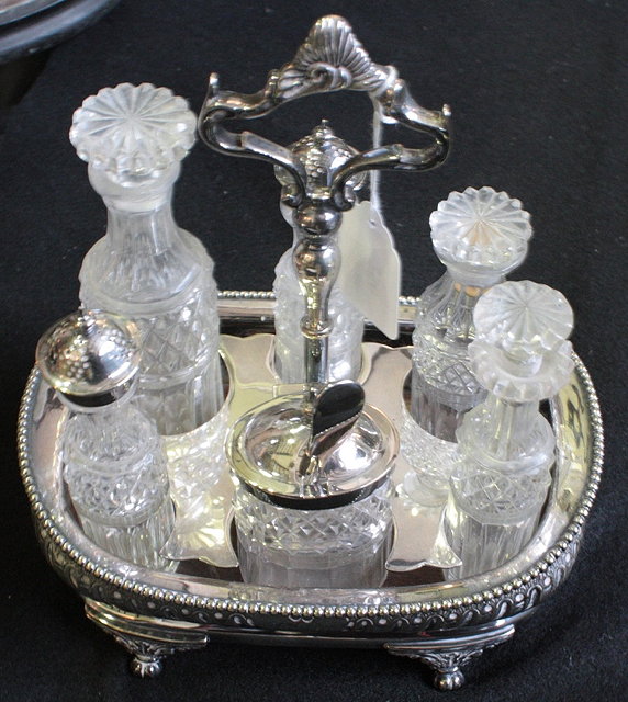 Appraisal: A VICTORIAN SILVER PLATED SIX BOTTLE CRUET with fluted body