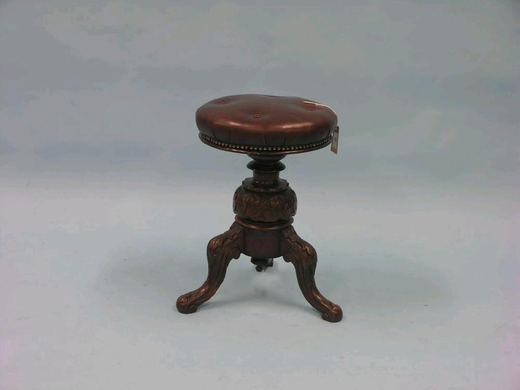 Appraisal: A Victorian mahogany piano stool buttoned leather seat revolving above