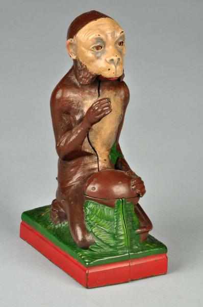 Appraisal: Cast Iron Monkey Coconut Mechanical Bank Description Working Manufactured by