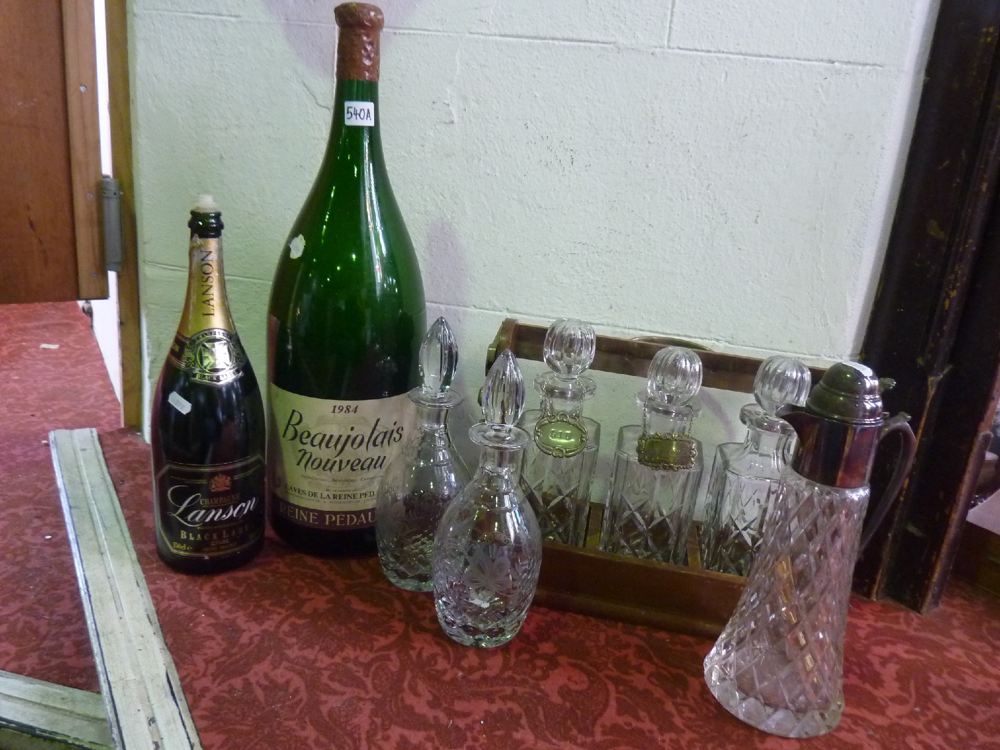 Appraisal: A tantalus with three decanters a Methuselah bottle once containing