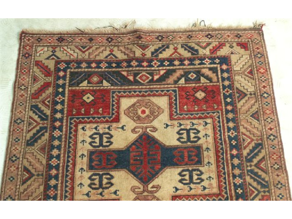 Appraisal: KAZAK RUG with two cruciform panels against a red ground