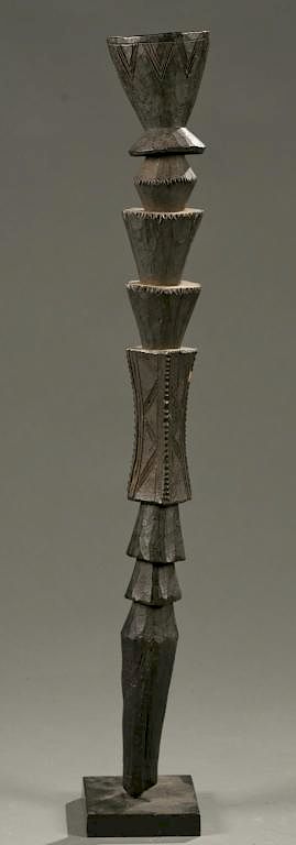 Appraisal: West African staff with geometric carvings A wooden carved staff