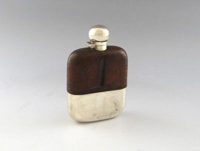 Appraisal: A silver mounted and crocodile skin hip flask rounded rectangular