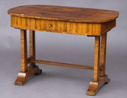 Appraisal: BIEDERMEIER WALNUT WRITING TABLE The oval top with rectangular cross-banded