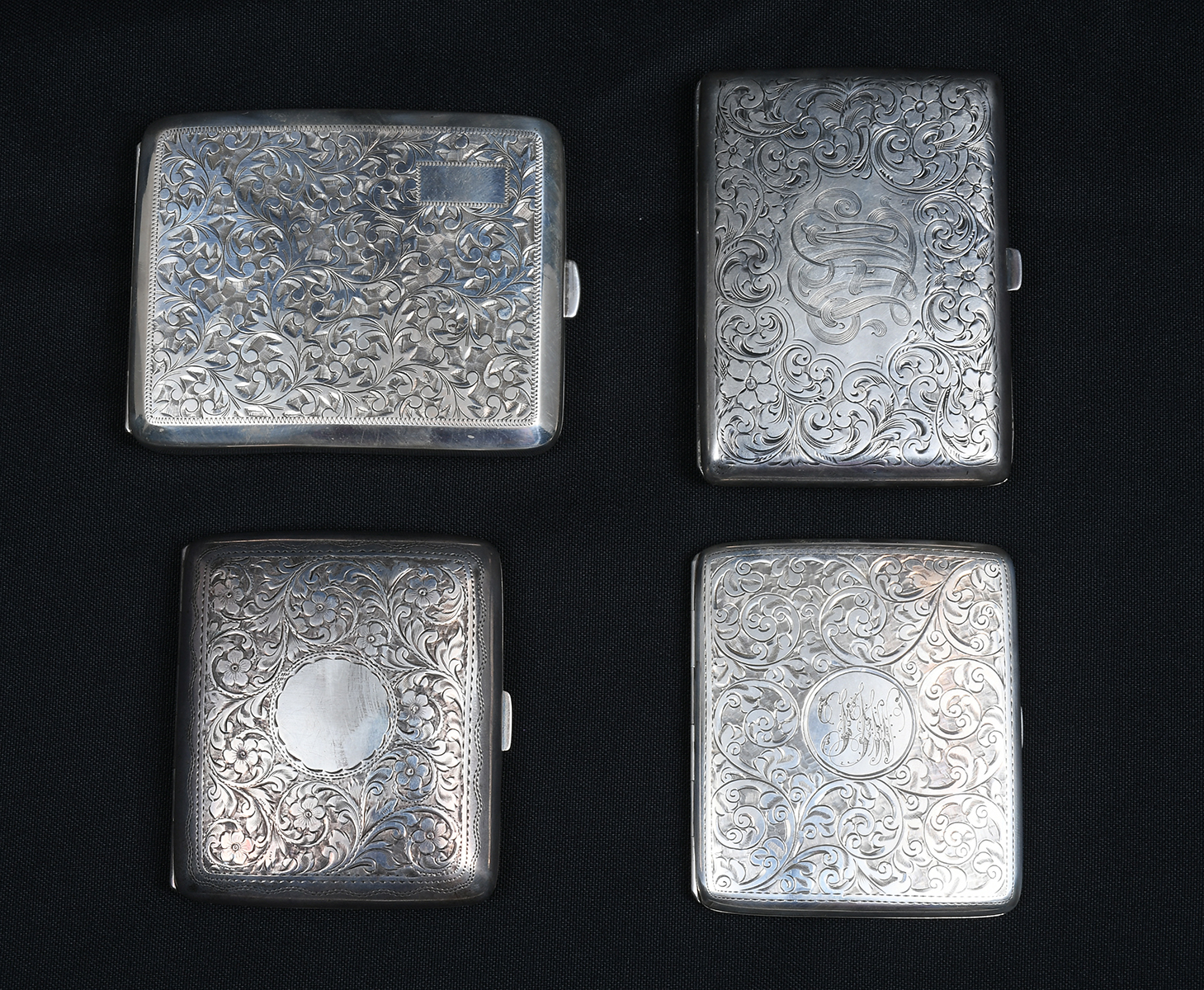 Appraisal: ENGRAVED STERLING SILVER CIGARETTE CASES All having scrolling foliate motifs