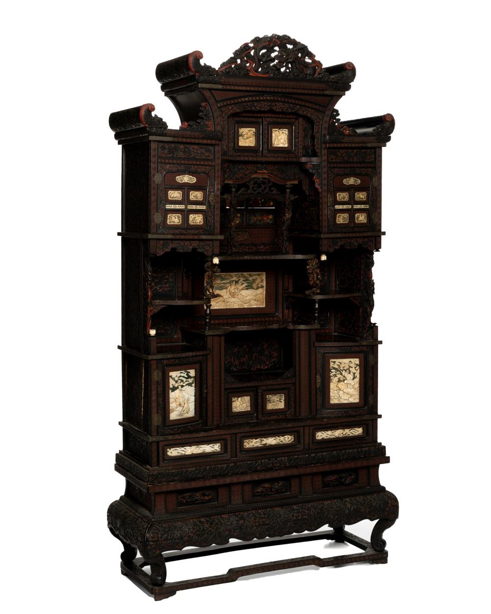 Appraisal: A Japanese carved hardwood cabinet on stand th Century The