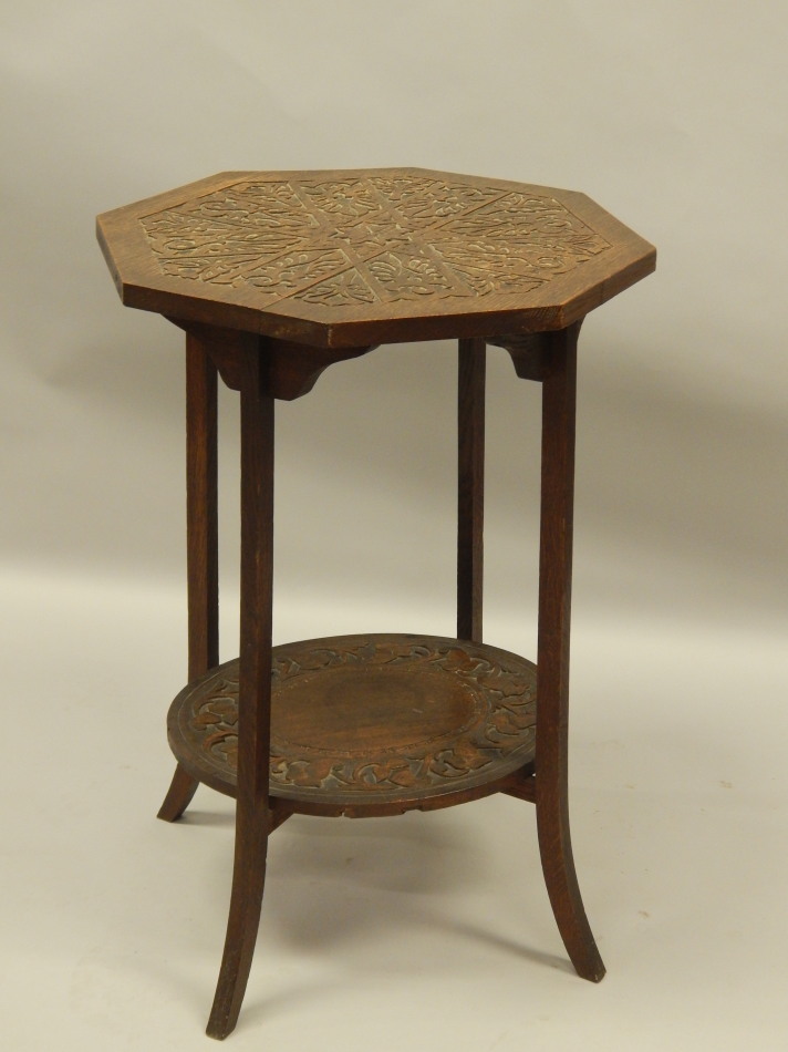 Appraisal: An early thC carved oak two tier occasional table on