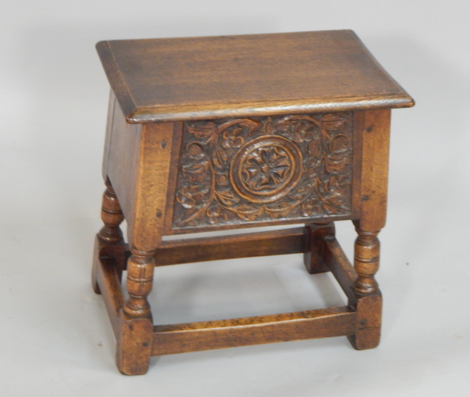 Appraisal: A Titchmarsh Goodwin carved oak work table with a rising