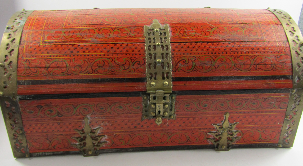 Appraisal: An Indian red painted and brass bound domed casket with